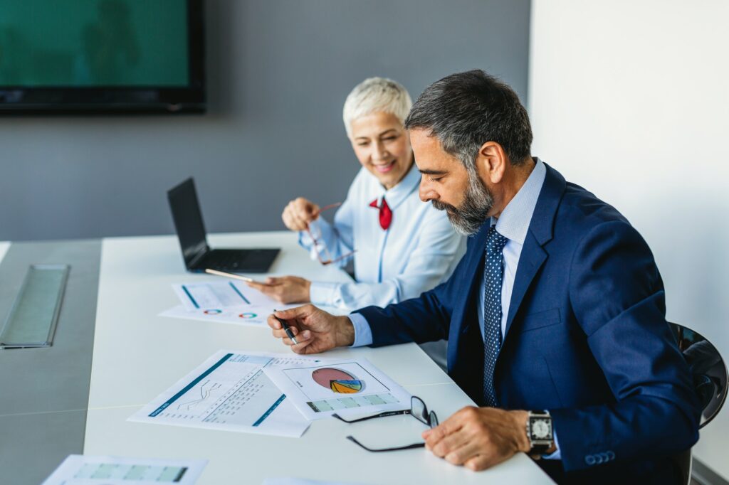 Business colleagues in conference meeting room during presentation